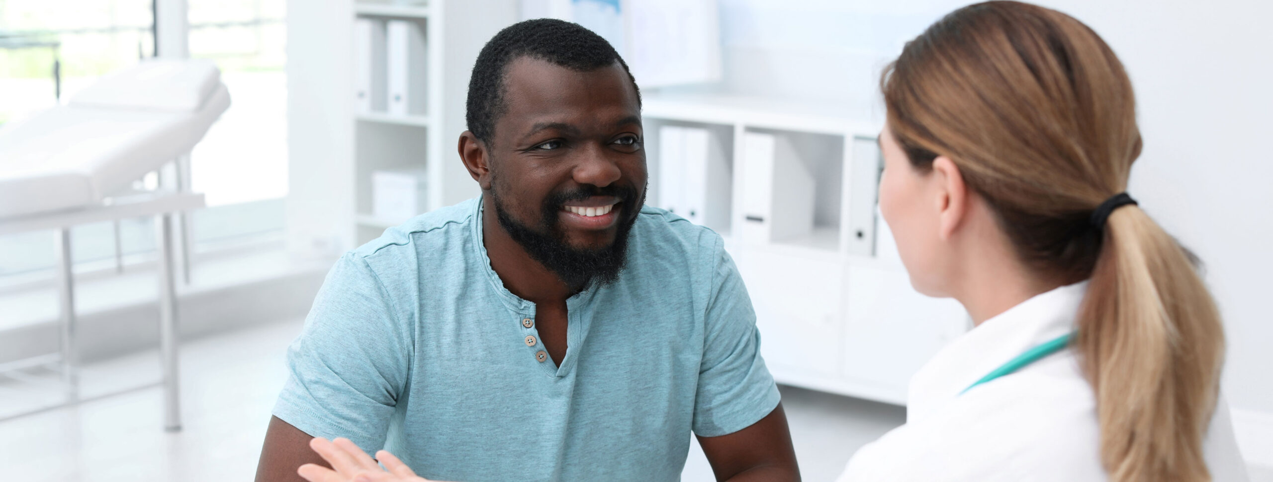 Man in blue shirt talking about Male Infertility with his doctor at ARMS | Arizona Reproductive Medicine Specialists