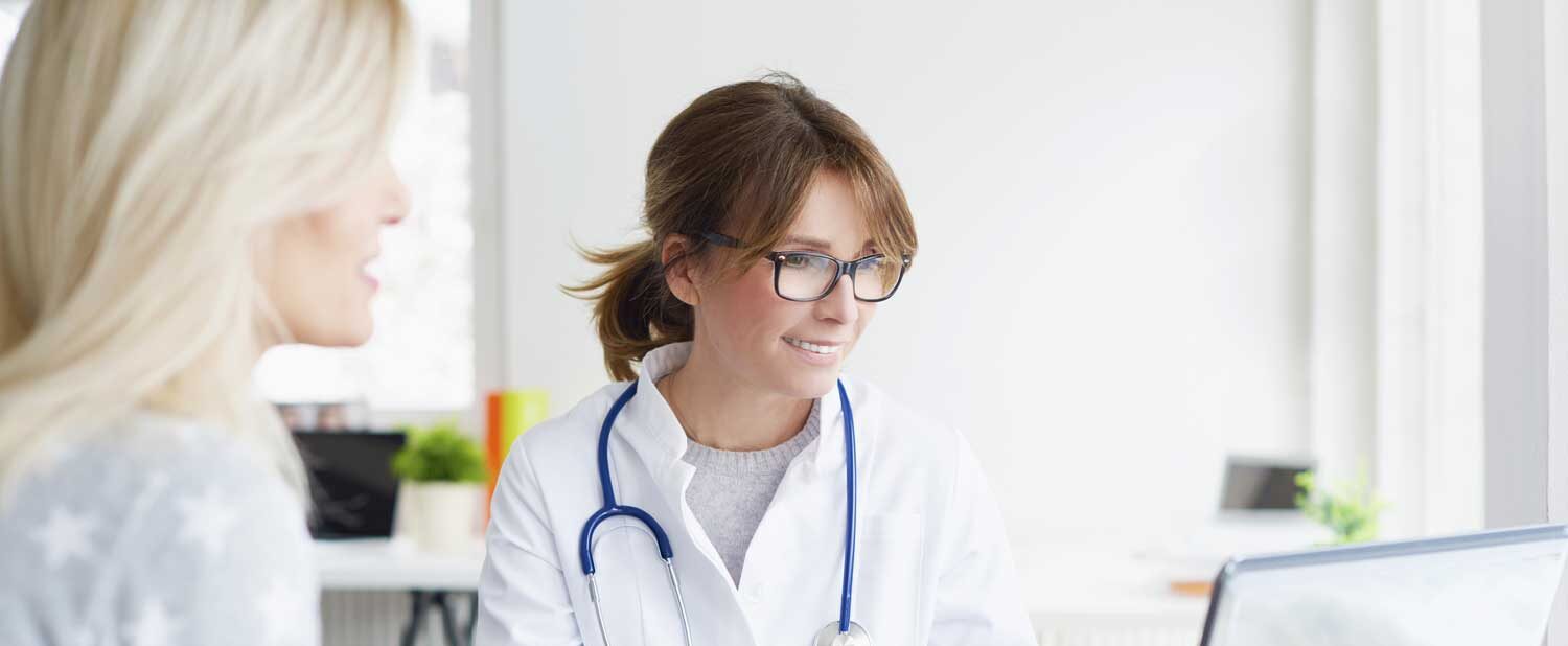 Female doctor discusses hysteroscopy fertility testing with female patient | Arizona Reproductive Medicine Specialists