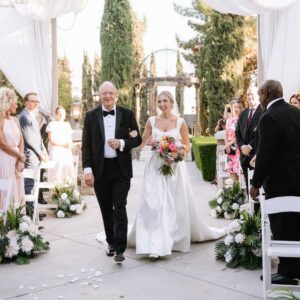 Dr. Moffitt walking his daughter down the aisle