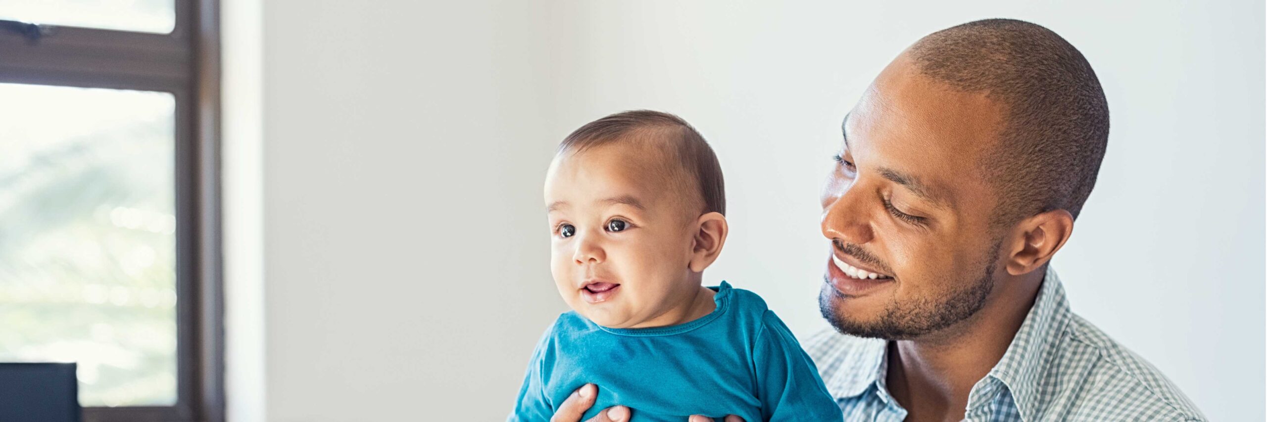 Father smiles at his son, conceived after a home sperm analysis was evaluated at ARMS