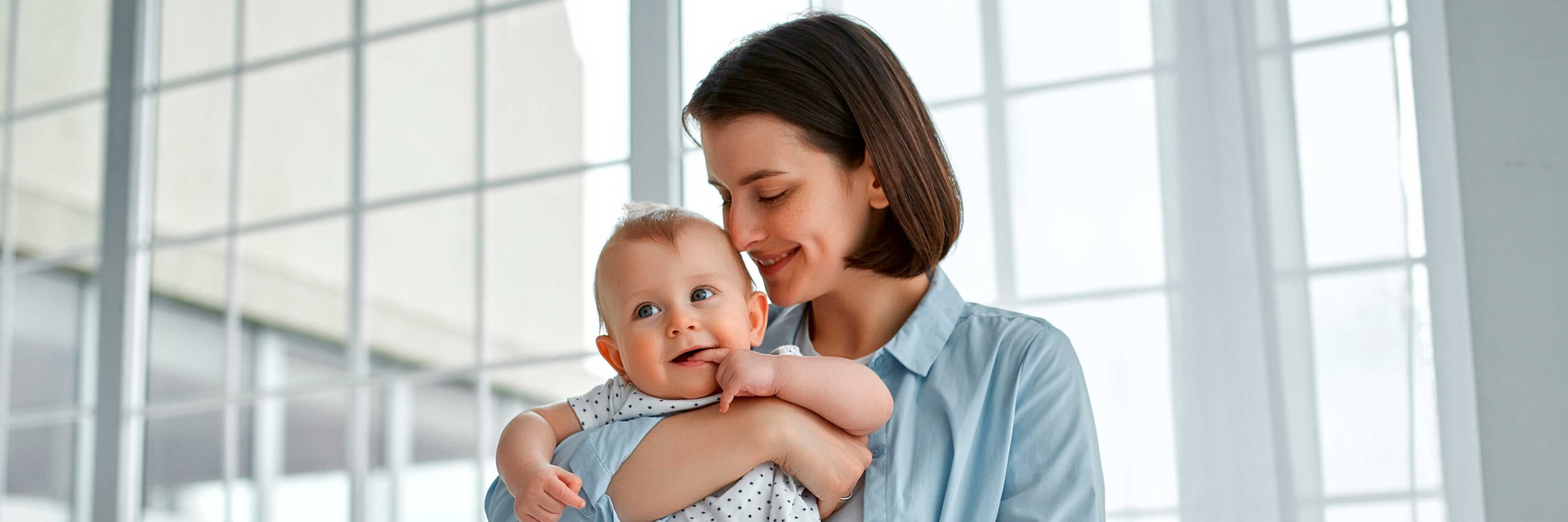 Smiling mother, who used a home ovarian reserve test kit, holds her newborn | Arizona Reproductive Medicine Specialists