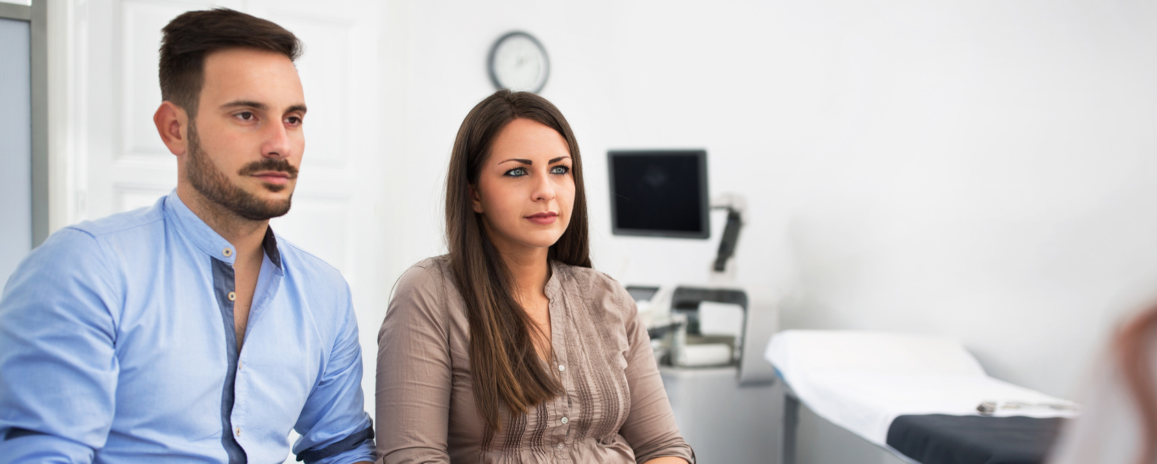 Couple discussing Intrauterine Insemination (IUI) with doctor | Arizona Reproductive Medicine Specialists